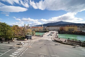 Explore the historic city center, where traditional and modern architecture meet, and a scenic river runs alongside.