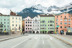 A street with colorful buildings, a mountain in the background, and a clear road. - Blackhome Innsbruck City Centre (Innsbruck)