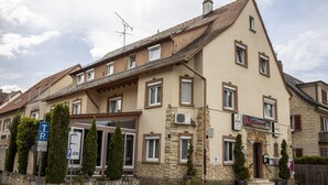 A two-story building with a stone facade, multiple windows, and a sign indicating a restaurant. - Hotel Restaurant Meteora (Tuebingen)