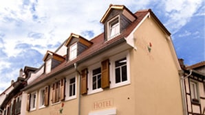 A traditional hotel with a sign indicating its name, a stone foundation, and a classic architectural style. - Kleine Villa Rose (Eltville am Rhein)