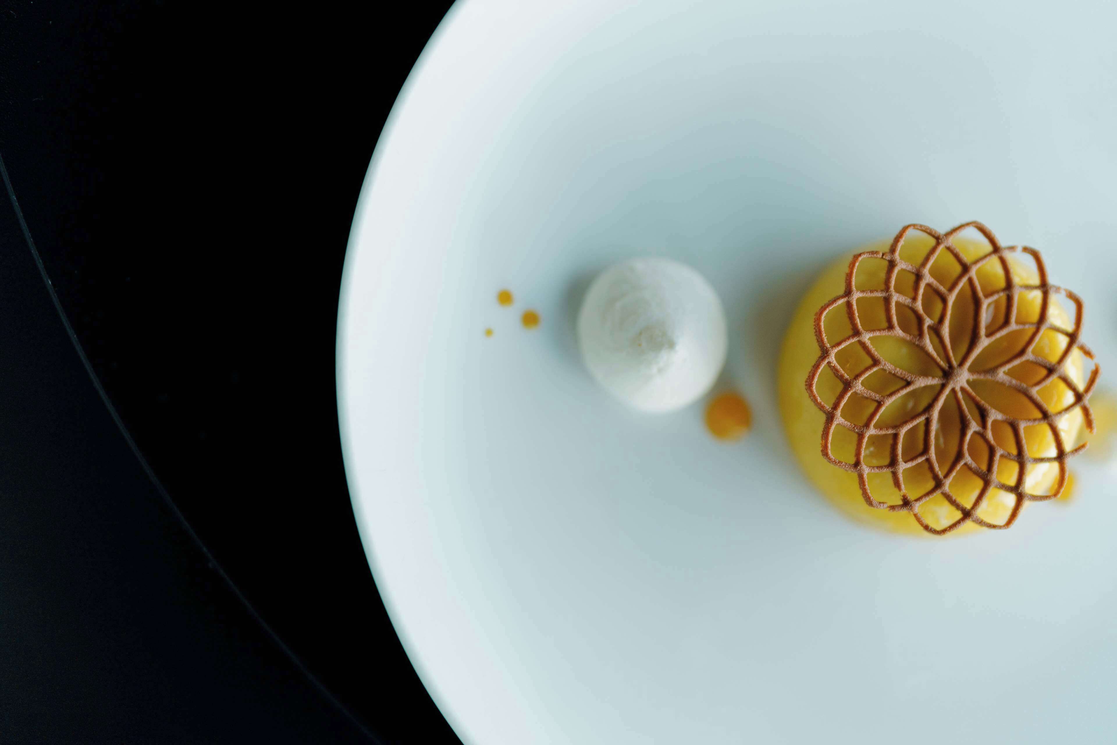 A dessert on a white plate with a decorative pattern.