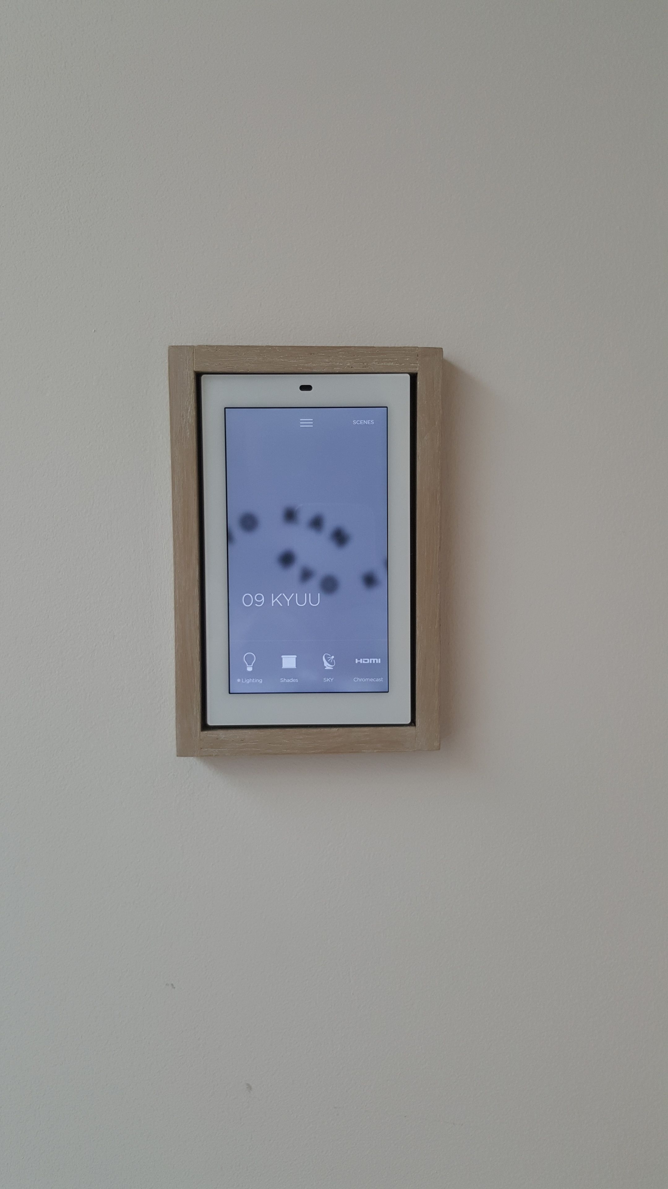 A framed digital display with a menu interface, including options for lighting, shades, sky, and Chromecast.