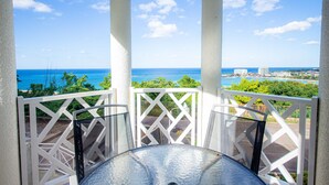 A balcony with a view of the ocean and cityscape. - Columbus Heights Ocean View Large Studio (Ocho Rios)