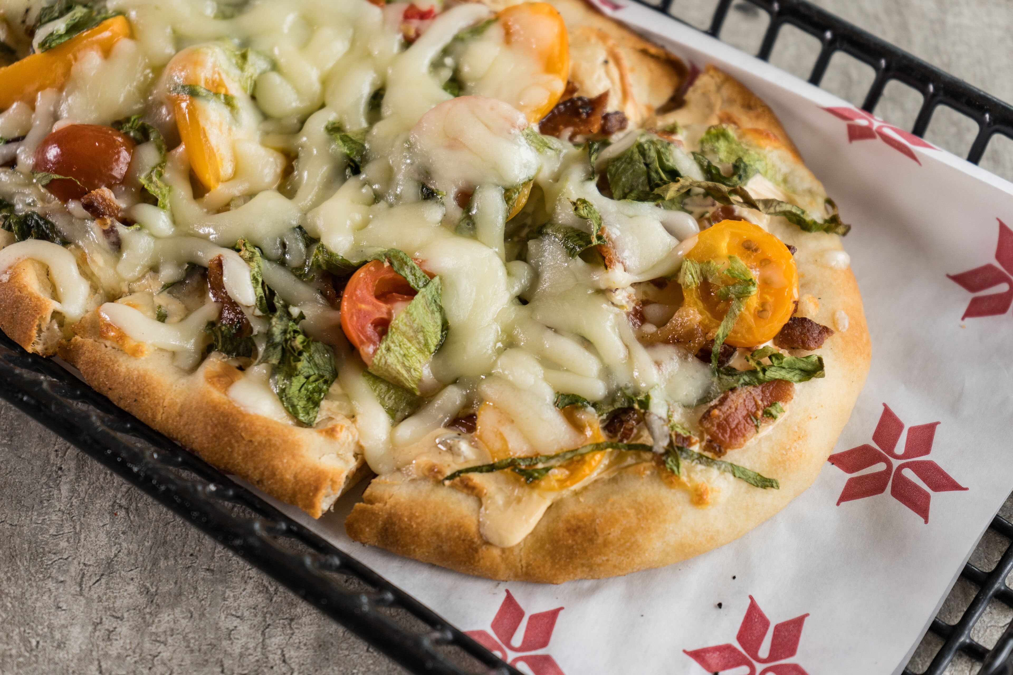 A pizza with various toppings on a tray.