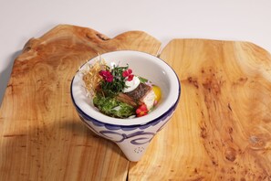 A bowl of food with a white and blue pattern, placed on a wooden surface. - Xolumado Inspiration Village by Karisma (Playa del Carmen)