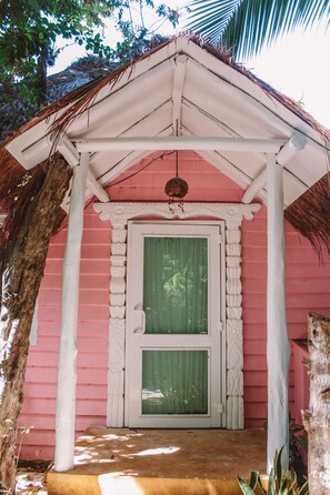 A pink building with a white porch and a green door. - Xolumado Inspiration Village by Karisma (Playa del Carmen)