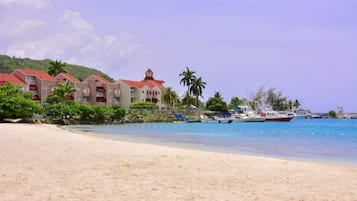 On the beach, white sand, beach cabanas, sun-loungers