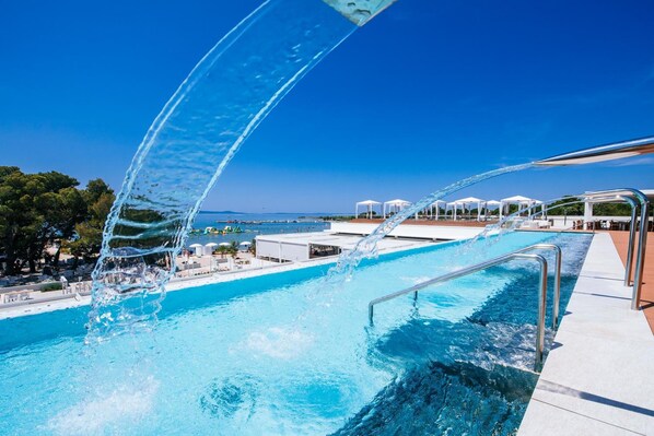 Relax by the pool surrounded by a spacious deck and lounge chairs.