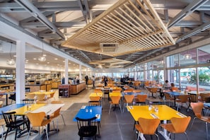 A spacious cafeteria with high ceilings, large windows, and a variety of seating arrangements. - Zaton Holiday Resort (Nin)