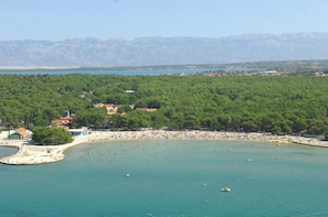 A coastal area with a beach, a small town, and mountains in the background. - Zaton Holiday Resort (Nin)