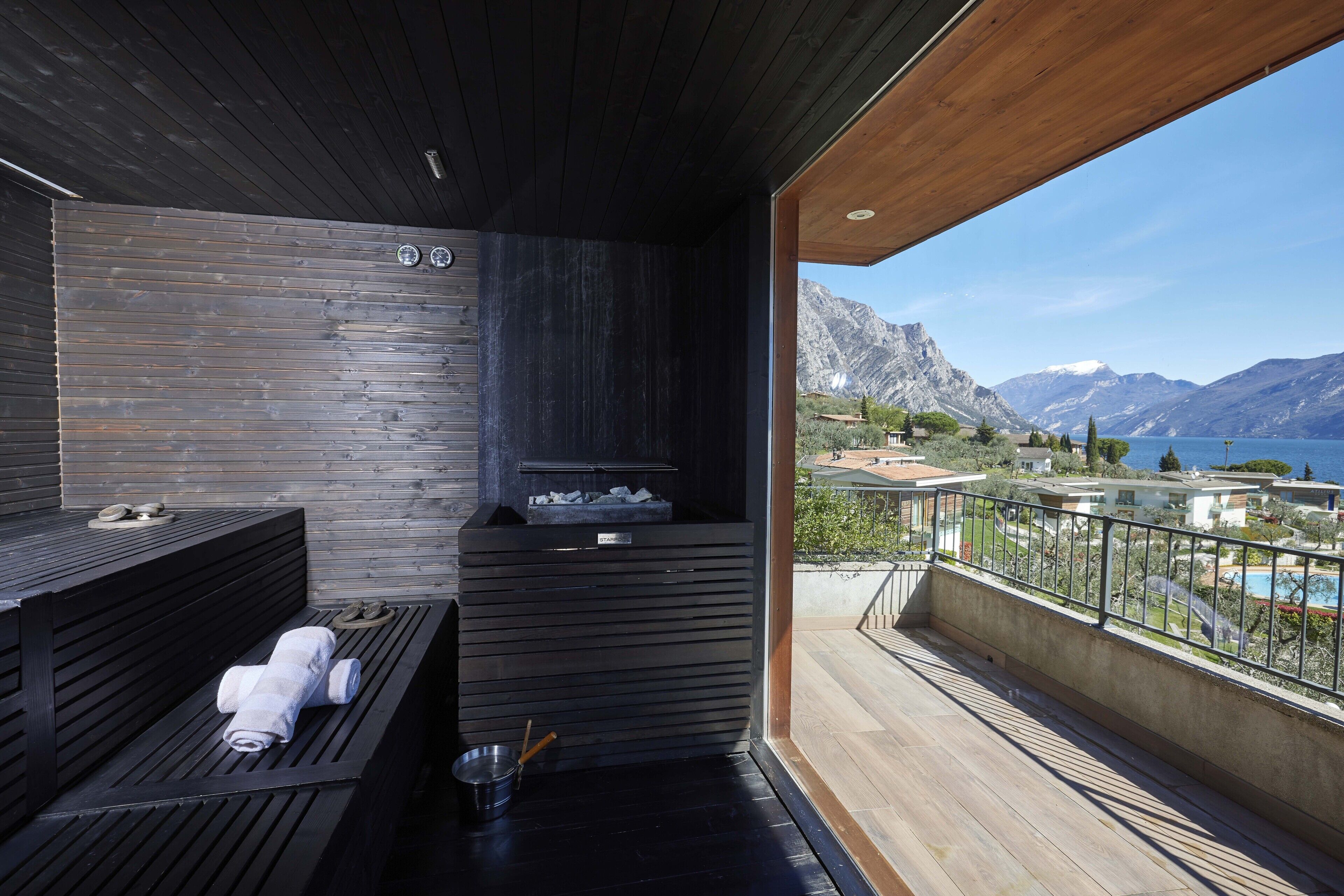 A modern sauna with a wooden interior, a bench, and a bench with a towel.