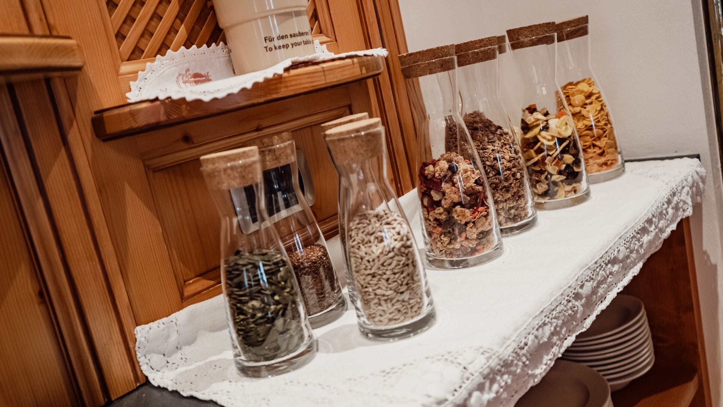 A table with various food items in glass containers.