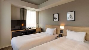 A hotel room with two beds, a desk with a TV, and framed pictures on the wall. - Best Western Hotel Fino Tokyo Akihabara (Tokyo)