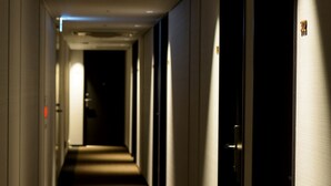 A long, narrow hotel corridor with doors on both sides and a carpeted floor. - Best Western Hotel Fino Tokyo Akihabara (Tokyo)