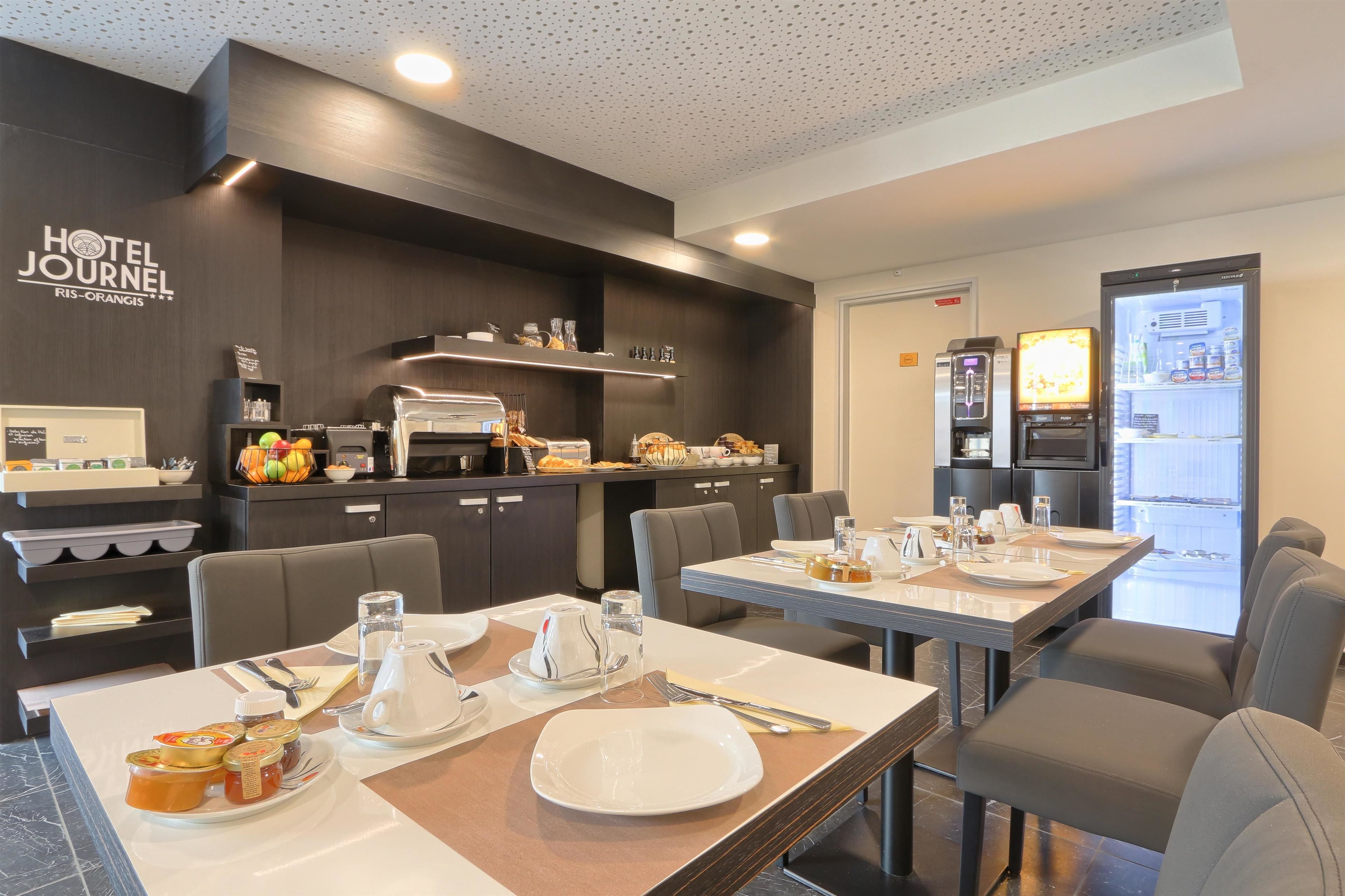 Habitación de hotel con kitchenette, desayunador y refrigerador.