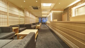 A modern library with seating areas, bookshelves, and a reception desk. - Narano Mori Hotel (Nara)