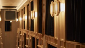 A hotel corridor with wooden paneling and wall-mounted light fixtures. - Narano Mori Hotel (Nara)