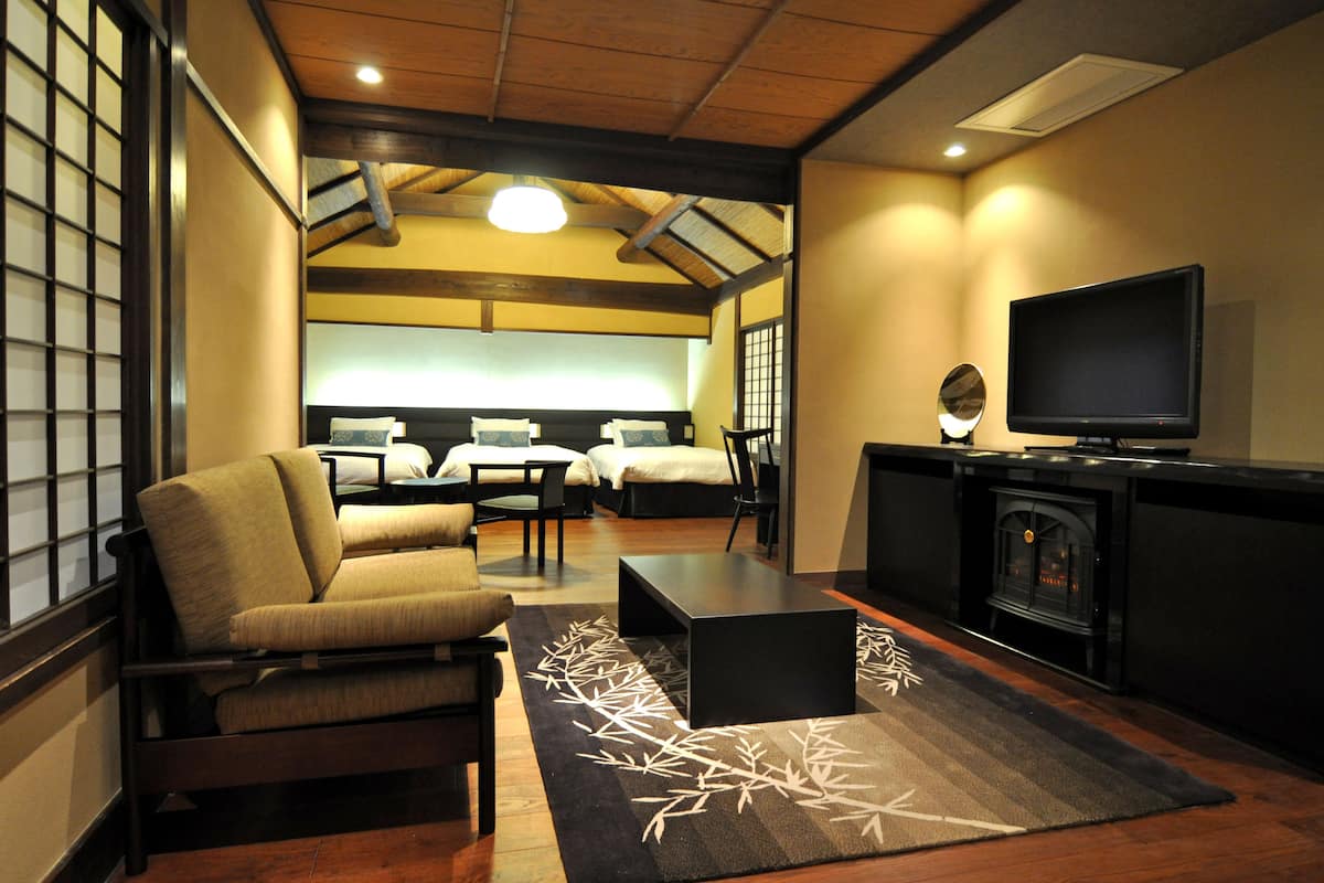 A modern living room with a sofa, a coffee table, and a television.