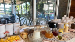 A breakfast buffet with various food items and utensils. - Chaophaya Thara Riverside (Chai Nat)