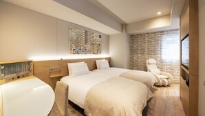 A modern hotel room with two beds, a seating area, and a cityscape artwork on the wall.