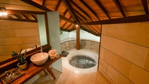 A bathroom with a large sink, a mirror, a bathtub, and a wooden ceiling. - Baliana Villa Umalas (Kerobokan)
