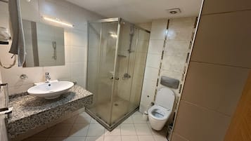 Shower, hair dryer, slippers, towels