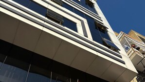 The exterior of the Pinar Elite Hotel with a prominent sign and a Turkish flag. - Pinar Elite Hotel (Adana)