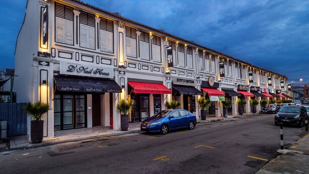 A row of shops with awnings, including a visible restaurant named "D.I. Tall House."