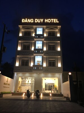 A multi-story building with a prominent illuminated sign reading "ĐÁNG DUY HOTEL". - Dang Duy Hotel (Phuoc Hoi)