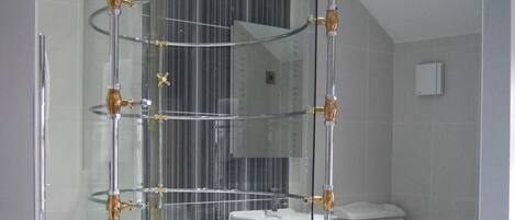 A bathroom with a freestanding bathtub, a glass-enclosed shower, and a toilet.