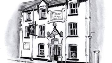 A building with a sign reading "The Plough Free House Rock Ale".