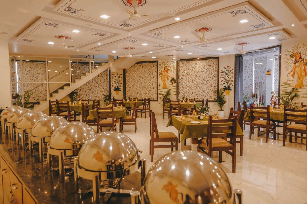 A restaurant with multiple dining tables, chairs, and decorative globes on the counter.