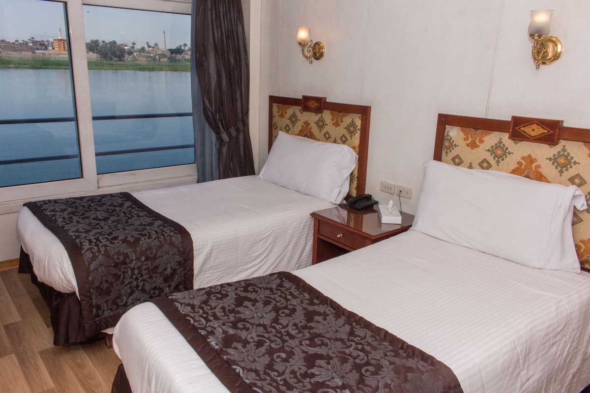 Standard Room, River View | Minibar, desk, blackout drapes, bed sheets