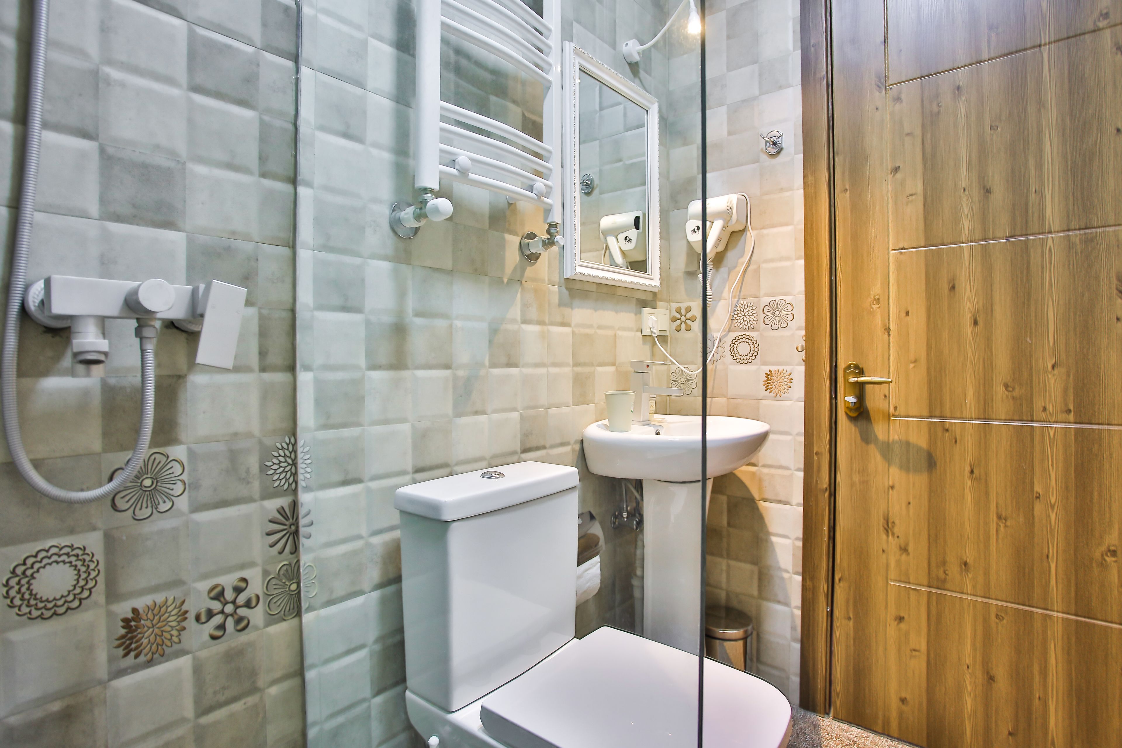 A bathroom with a toilet, sink, and shower.