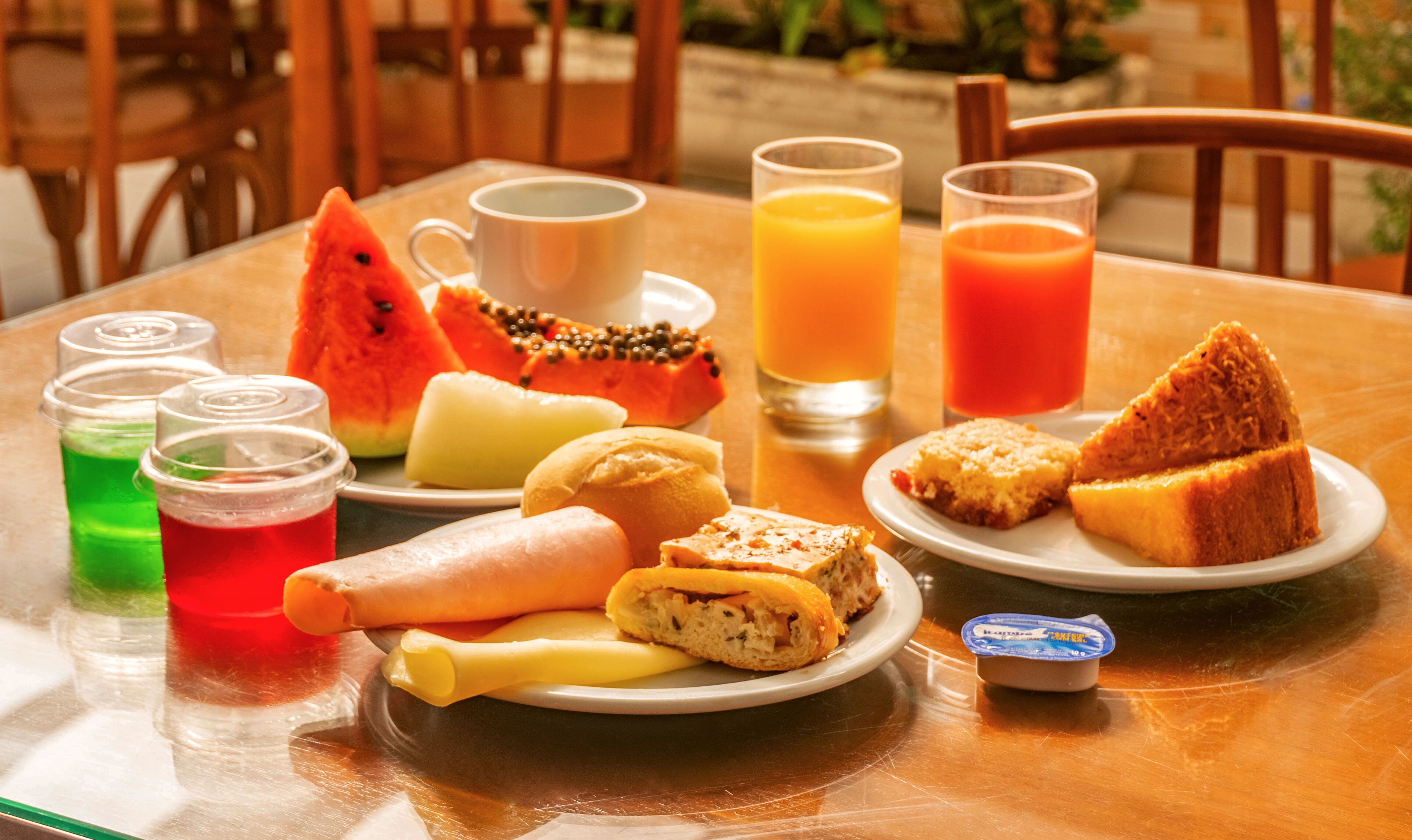 A breakfast table with various food items and drinks.
