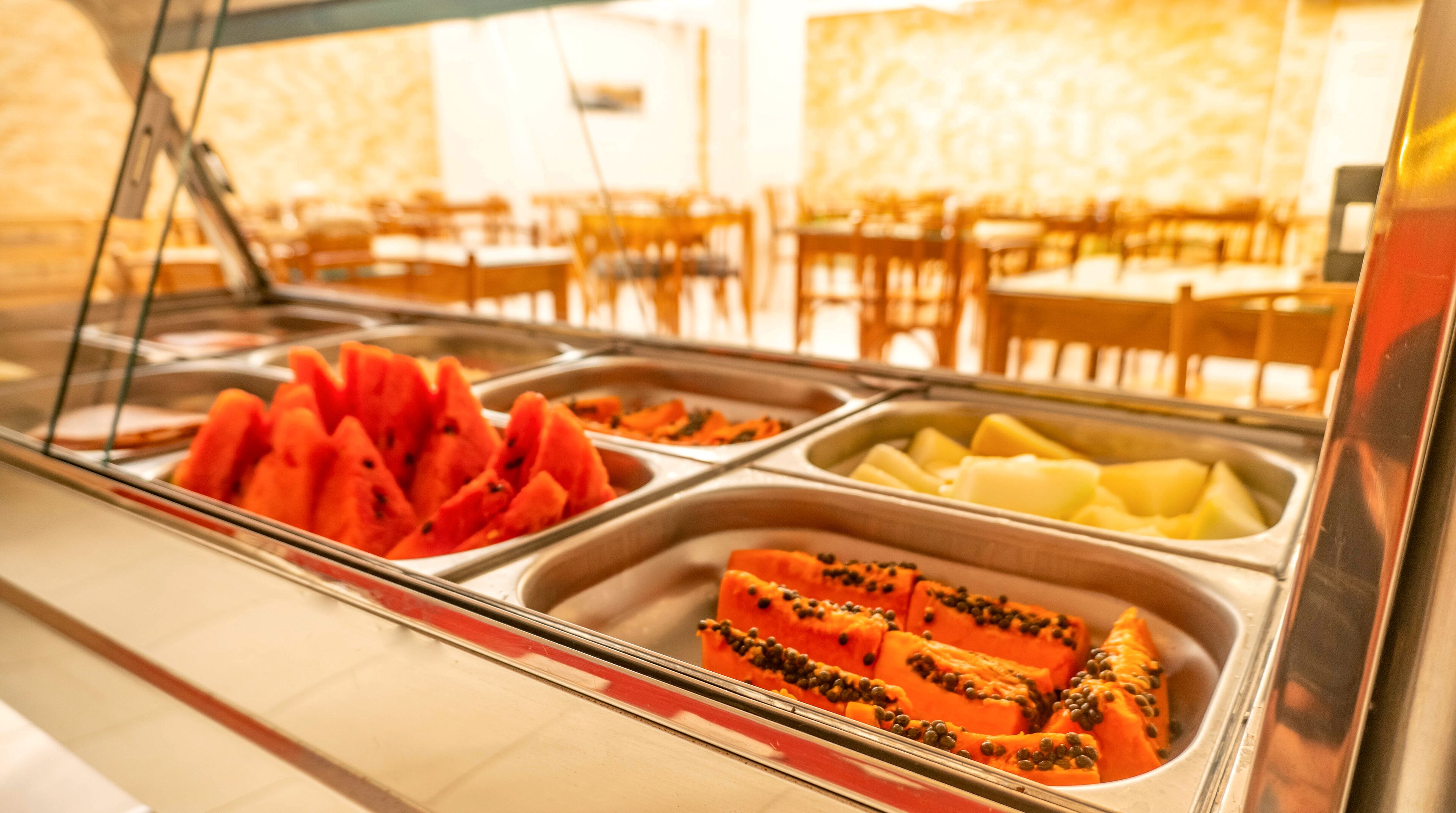 A buffet with various fruits and vegetables.