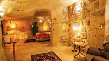 Room 9 Honeymoon Deluxe Cave Suite | Coin séjour | Télévision de 70 cm avec chaßnes par satellite