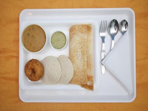A white tray with a crepe, two small round items, and two small bowls of sauce. - Hotel Hotel Suprabha (Hanmakonda)