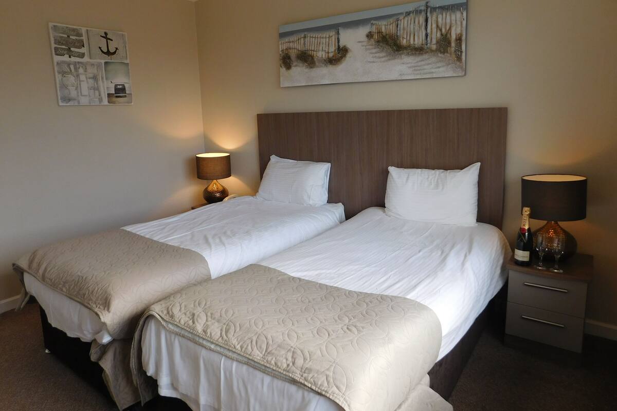 Premium bedding, blackout drapes, iron/ironing board (on request)