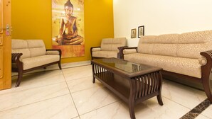 A living room with a sofa, two armchairs, and a glass coffee table. - OYO 16593 Home Luxury 3BHK Galaxy Villa Andrar (Dharamshala)