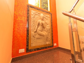 A marble wall with a framed bas-relief sculpture. - OYO 16593 Home Luxury 3BHK Galaxy Villa Andrar (Dharamshala)