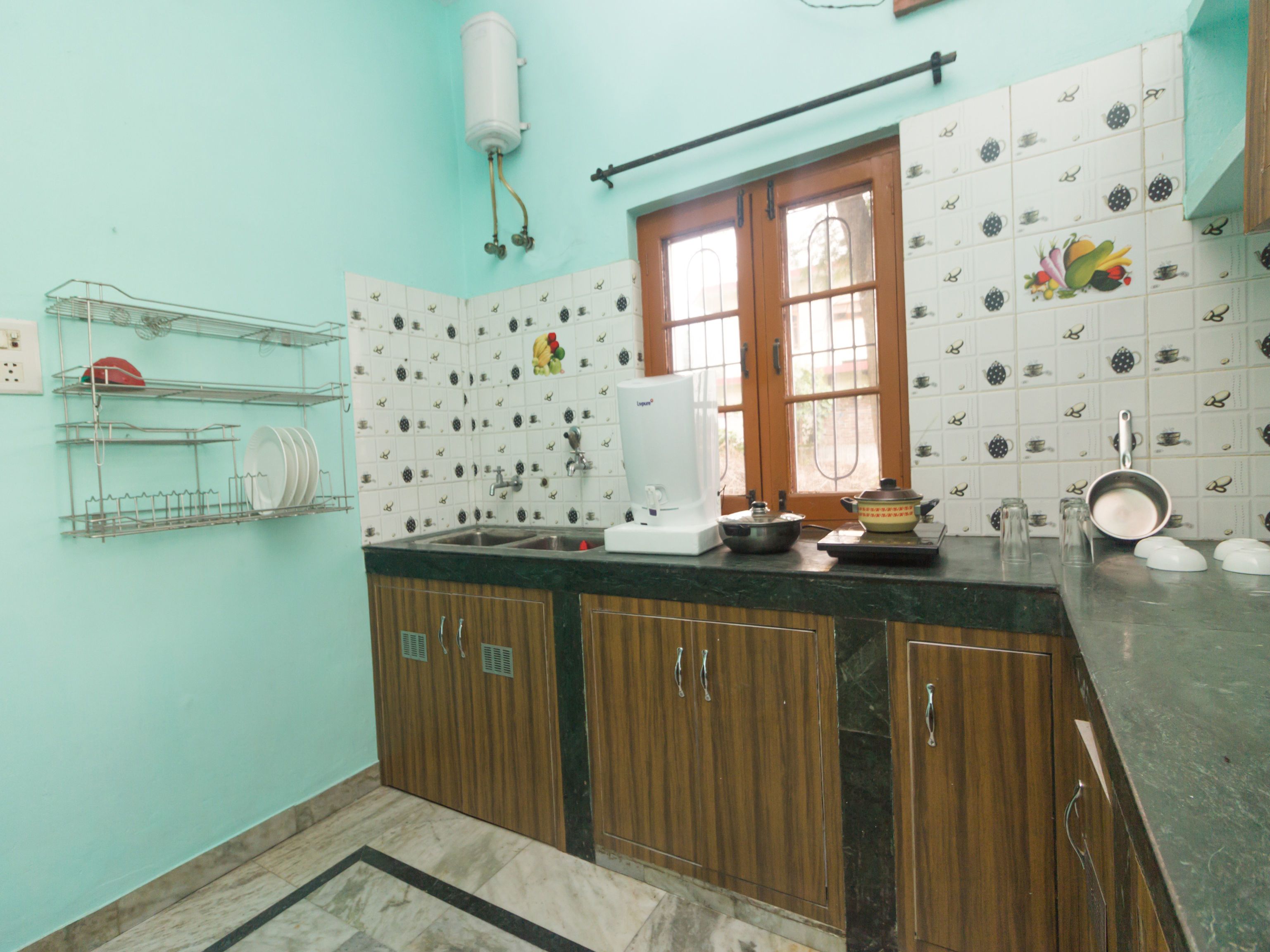A kitchen with wooden cabinets, a sink, and a window.