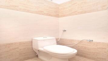 A bathroom with a toilet, a shower, and tiled walls.