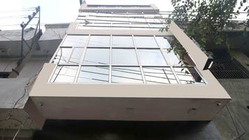 A modern building with a large glass facade and a flat roof.