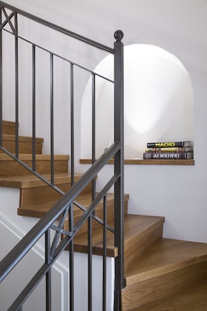 A staircase with wooden steps and metal railings. - Mamilla Design Apartments (Jerusalem)