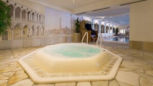 A large indoor hot tub with stone flooring, surrounded by a corridor with arches and a mural of a mosque. - Wellnesshotel Schonruh - Adults Only (Seefeld in Tirol)