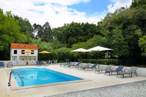Piscine extérieure, parasols de plage, chaises longues