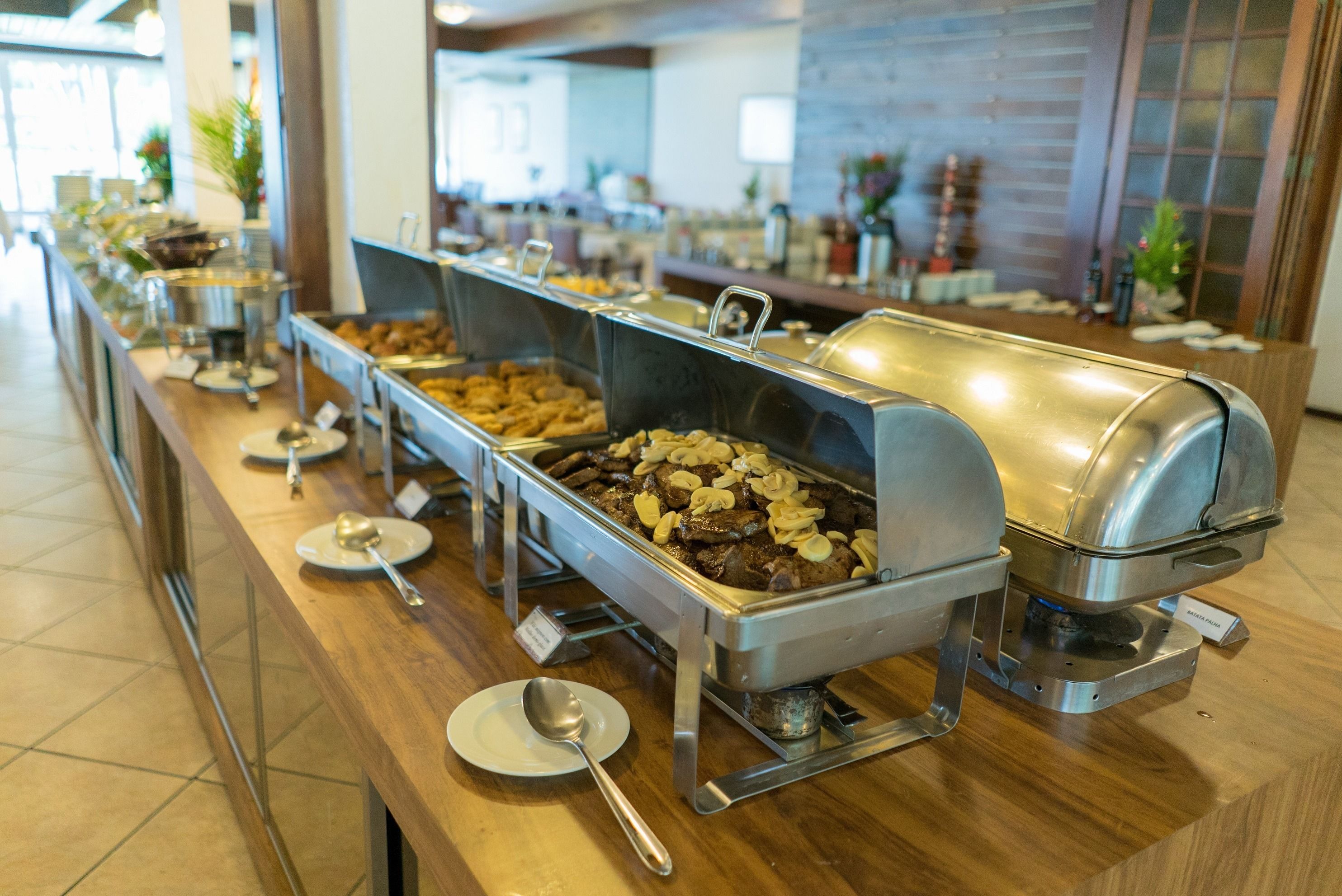 A buffet with various food stations, including a grill and a salad bar.