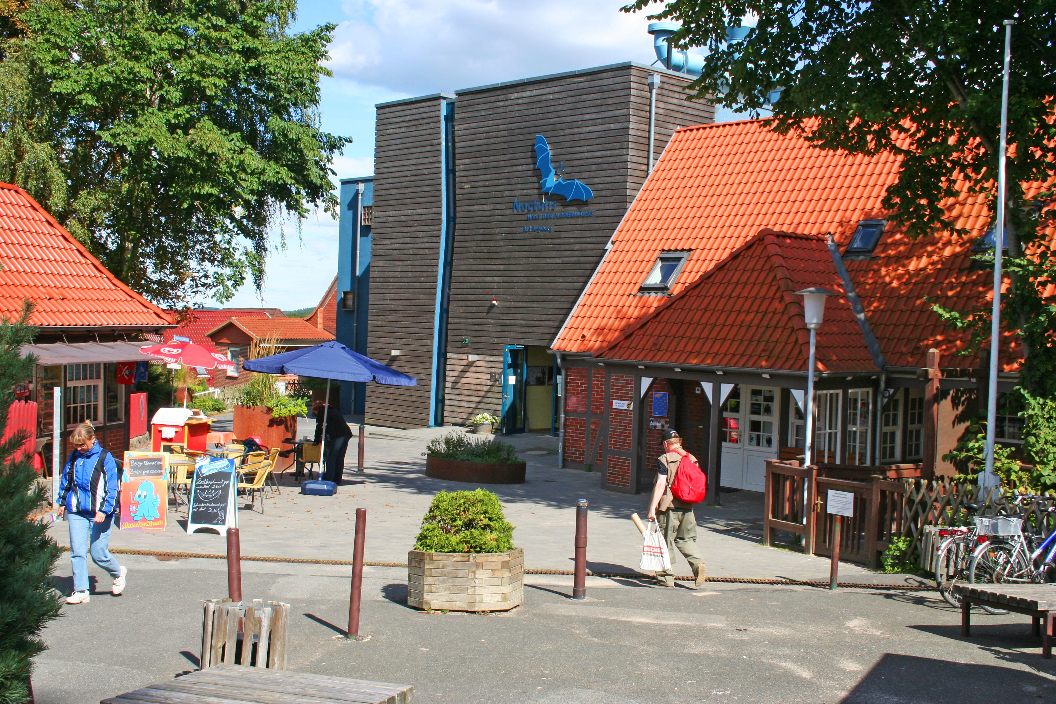A building with a wooden facade and a red-tiled roof.