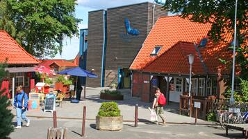 A building with a wooden facade and a red-tiled roof.